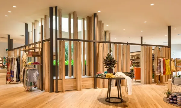 Anthropologie Oklahoma City: reclaimed cedar columns around a skylit garden, a round table in front