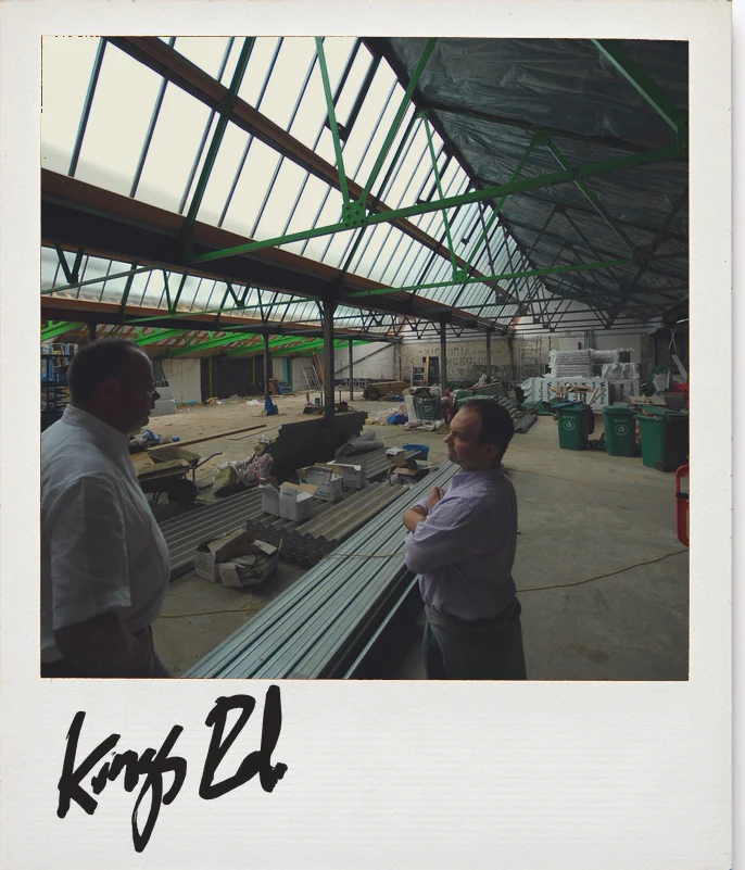 Photo, Anthropologie King&rsquo;s Road, London, during the build: two people talking under the glazed roof of the hall